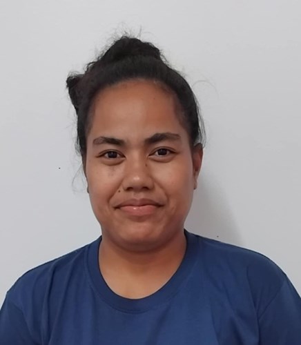 A headshot photo of Rose. Rose is wearing a blue top, her hair is pulled back, she is smiling and there is a white background.